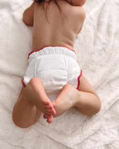 Baby wearing a Geffen Baby Fitted cloth diaper with snaps. Organic cotton is soft and comfortable. 