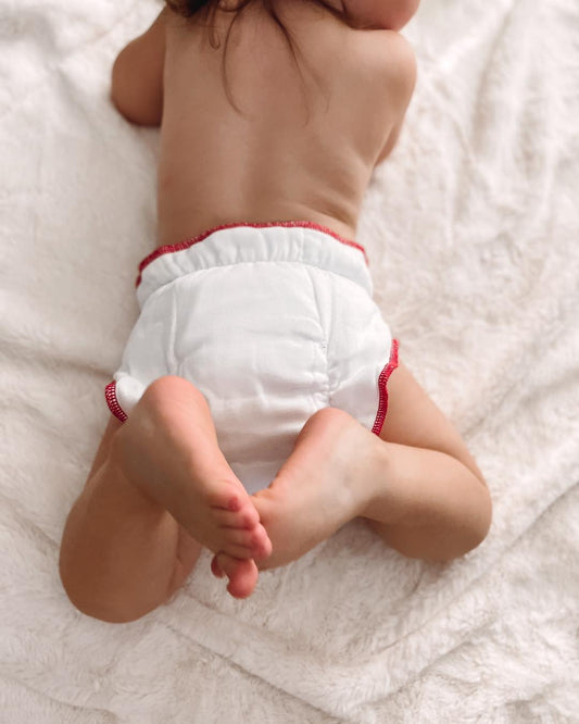 Baby wearing a Geffen Baby Fitted cloth diaper with snaps. Organic cotton is soft and comfortable.